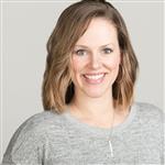 A headshot of Kammy Meyers wearing a grey sweater